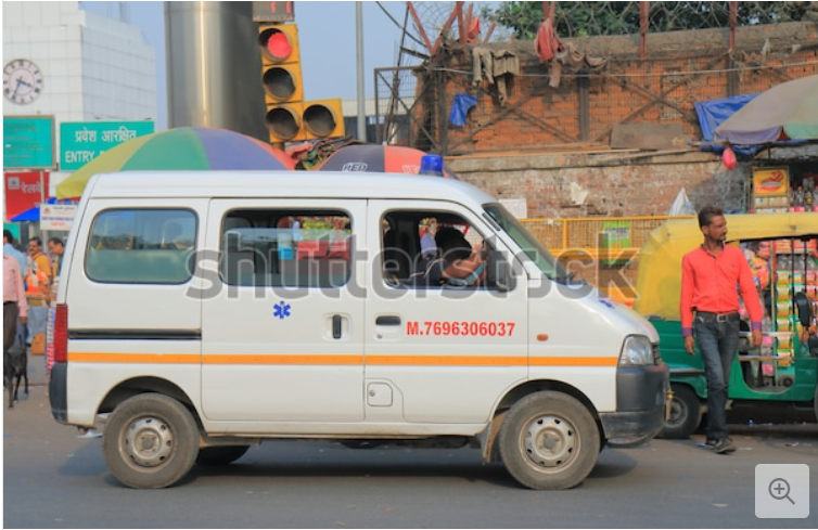 Reference photograph of an Indian ambulance: a white van with an orange stripe and a blue star of life on the side.